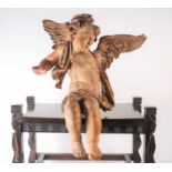 A painted and carved-wood winged cherub, possibly 18th century, 51 cm high x 45 cm (a/f).Condition