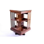 An Edwardian marquetry inlaid mahogany, revolving library bookcase in the manner of Edwards and