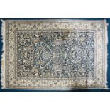 A 20th century Nain rug with flowering shrub and animal scheme on a dark blue ground. Within