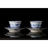 A pair of Chinese, Kangxi blue and white porcelain tea bowls and saucers decorated with carp and