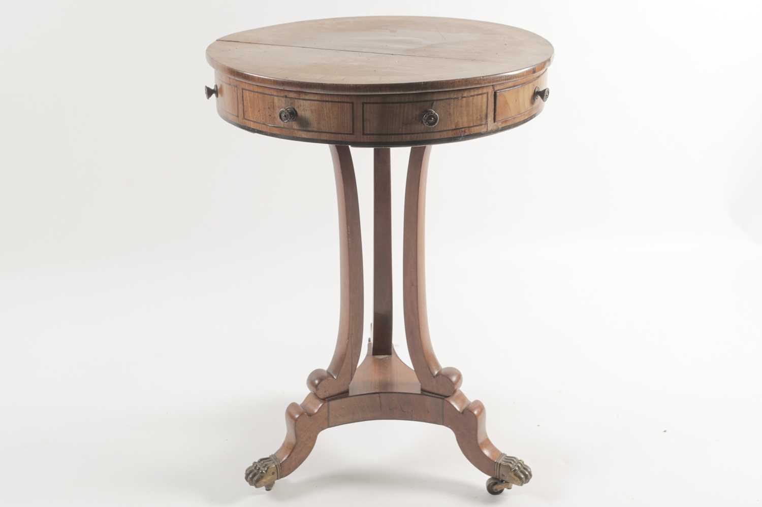 A small George IV ebony strung mahogany circular drum form urn table with tulipwood banded top and