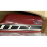 Two Yamaha red fuel tanks.
