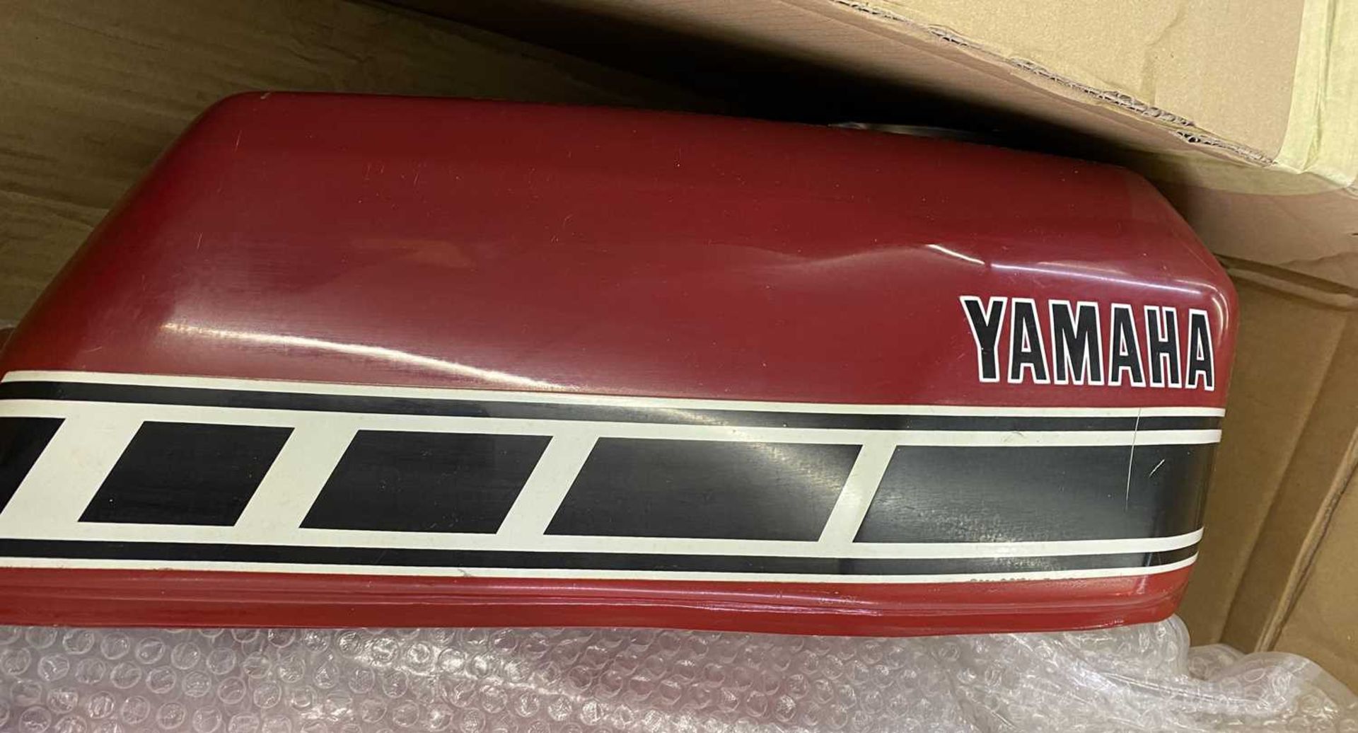 Two Yamaha red fuel tanks.