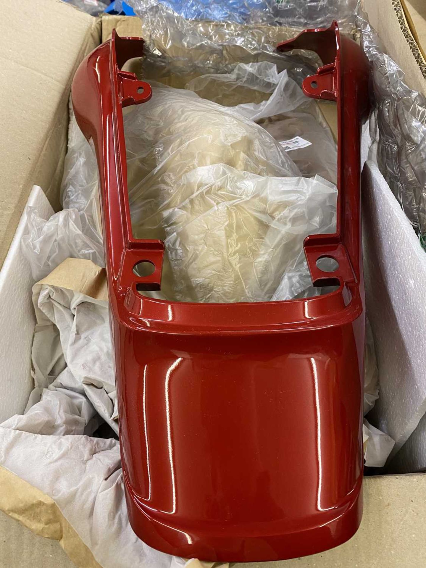 A Yamaha FZX750 red panel set, two boxes of spare parts, brake calipers, together with a folder of