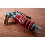 A BMW S1000RR OEM rear shock absorber suspension unit.