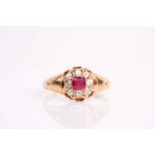 A late 19th / early 20th century yellow metal, diamond, and ruby cluster ring, set with eight old