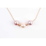 A three stone mixed colour cultured pearl necklace, the three pink and cream tone pearls strung on a