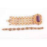 A late 19th / early 20th century gilt metal bracelet, set with a large faceted amethyst-coloured