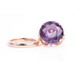 A yellow metal and synthetic corundum ring, set with a mixed round-cut stone with Alexandrite