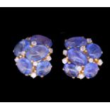 A pair of cabochon sapphire and diamond cluster earrings; the ten mixed size polished stones claw-