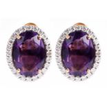 A pair of amethyst and diamond cluster earrings, set with a mixed oval-cut amethyst within a