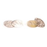 A pair of 9ct yellow gold cufflinks, with oval plaques, one with floral engraved decoration, the