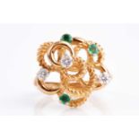 An 18ct yellow gold, diamond and emerald abstract ring, the raised rope-twist mount inset with three