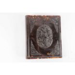 An early 20th Chinese carved and pierced tortoiseshell, hinged book cover with central oval relief