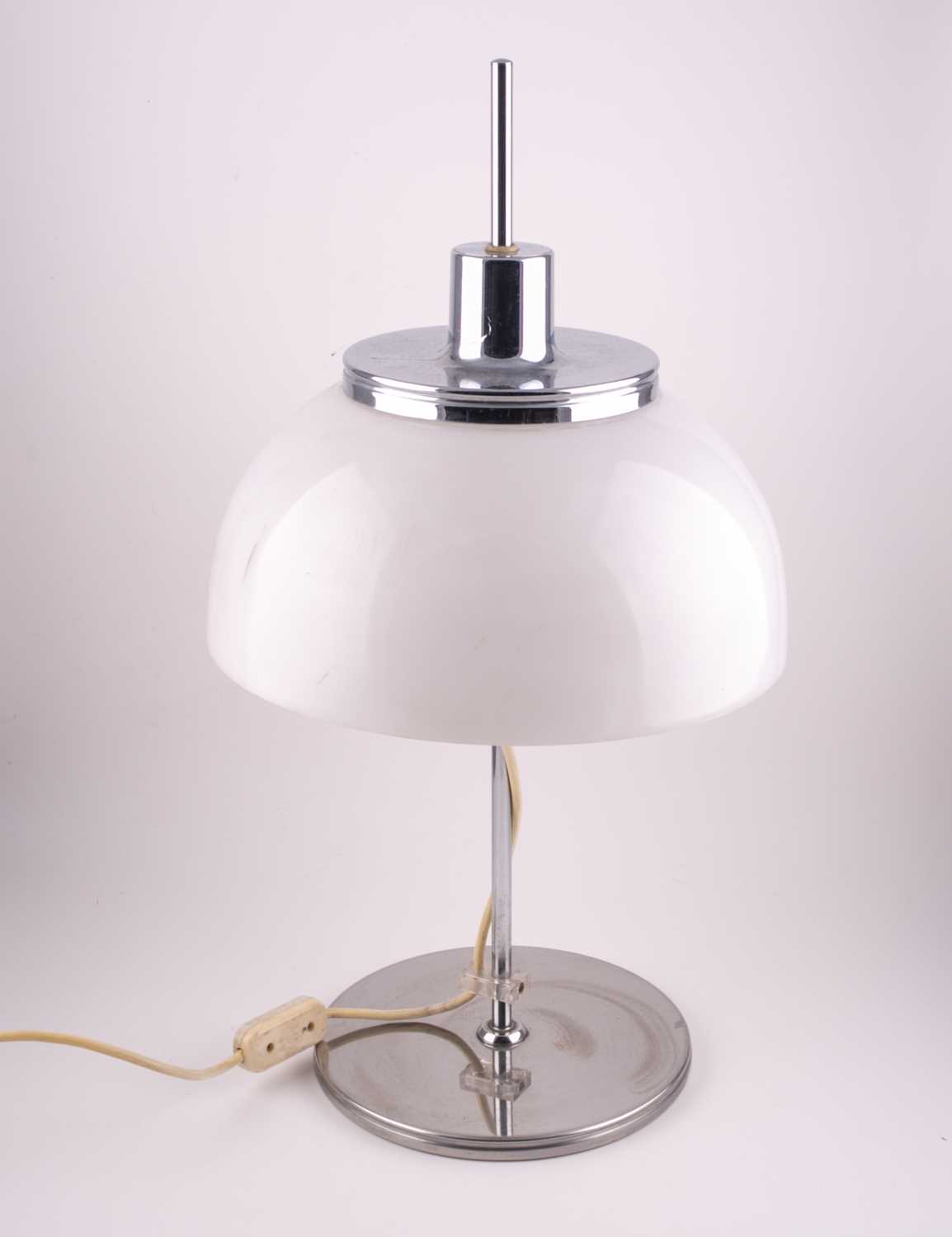 A Harvey Guzzini chrome and plastic table lamp, with adjustable shade