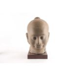 A composition stone bust of Buddha, 20th century, modelled with a serene expression, on a rosewood