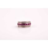 An Art Deco three row half hoop ruby and diamond eternity ring; the central band of calibre cut