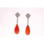 A pair of diamond and carnelian drop earrings, each with a faceted pear-drop carnelian, beneath a
