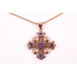 A yellow metal and synthetic corundum cross pendant, set with five mixed round-cut stones, the