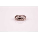 A platinum and diamond ring; the curved 'D' shaped band inset with four round brilliant cut