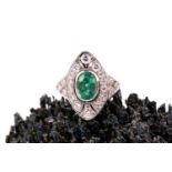A platinum, diamond, and emerald ring, set with a mixed oval-cut emerald, within a navette-shaped