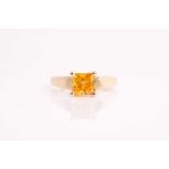 A diamond ring, set with a princess-cut natural fancy vivid yellowish orange diamond, approximate
