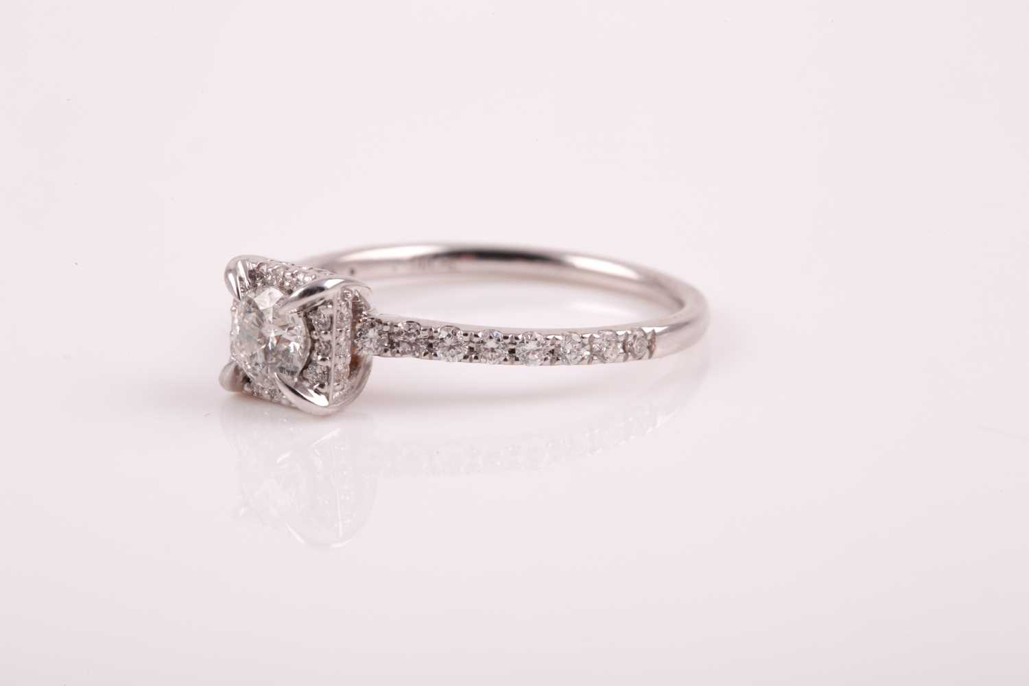 A 14ct white gold and diamond cluster ring, set with a round brilliant-cut diamond of - Image 6 of 7