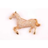 A yellow gold and diamond brooch in the form of a prancing horse, pave-set with diamonds of