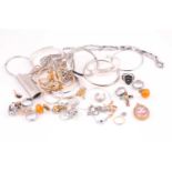 A group of various costume jewellery items, including white metal bangles, various chains,