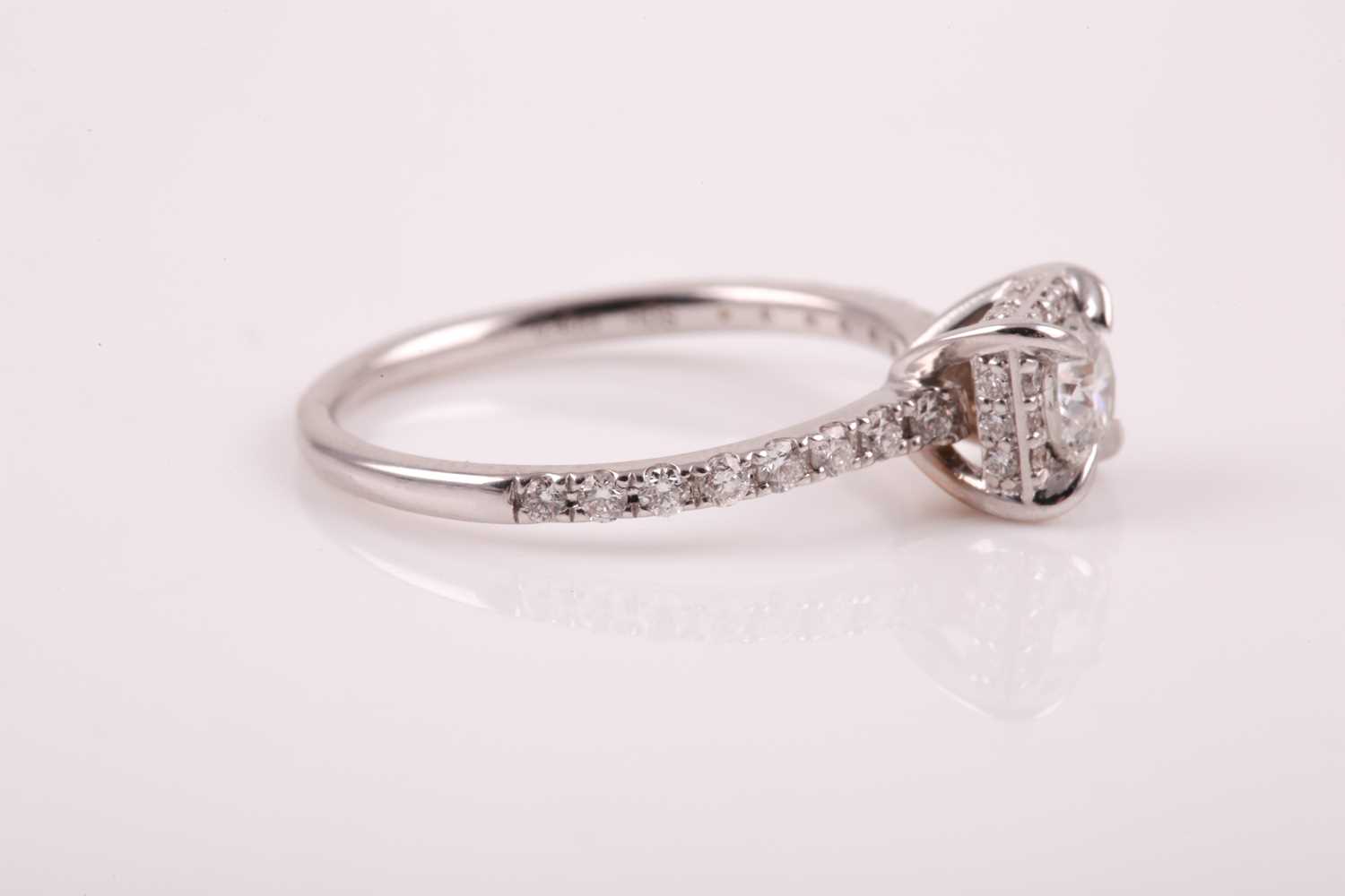 A 14ct white gold and diamond cluster ring, set with a round brilliant-cut diamond of - Image 4 of 7