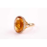 A 14ct yellow gold, diamond, and citrine cocktail ring, set with a large mixed oval-cut citrine