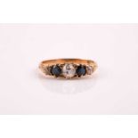 An Edwardian sapphire and diamond five stone half hoop ring; the old brilliant cut diamonds and