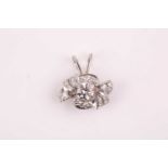 An unusual diamond pendant, the scrolled design centred with a round brilliant-cut diamond of