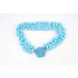 A turquoise-coloured bead necklace, possibly dyed howlite, set with three strands of rounded pear-