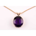 A yellow metal, diamond, and amethyst pendant, set with a deep purple mixed oval faceted amethyst,