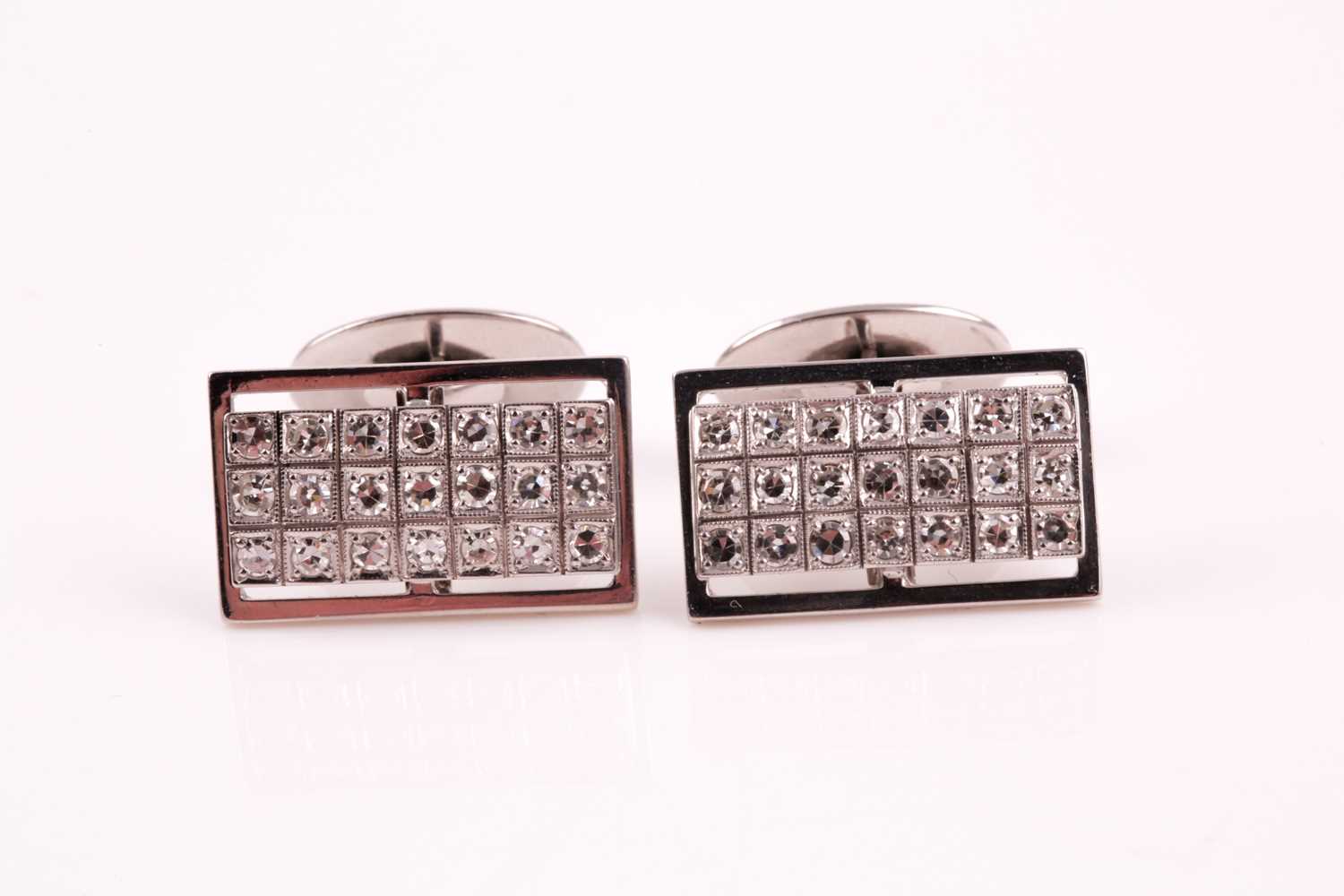 A pair of diamond cluster cufflinks, the rectangular plaques pave set with twenty one round