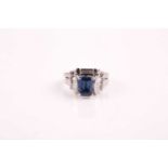 A 14ct white gold, diamond, and sapphire ring, set with a mixed rectangular-cut sapphire of