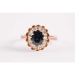 An 18ct yellow gold, sapphire, and white stone cluster ring, size M 1/2.Condition report: 5 grams.