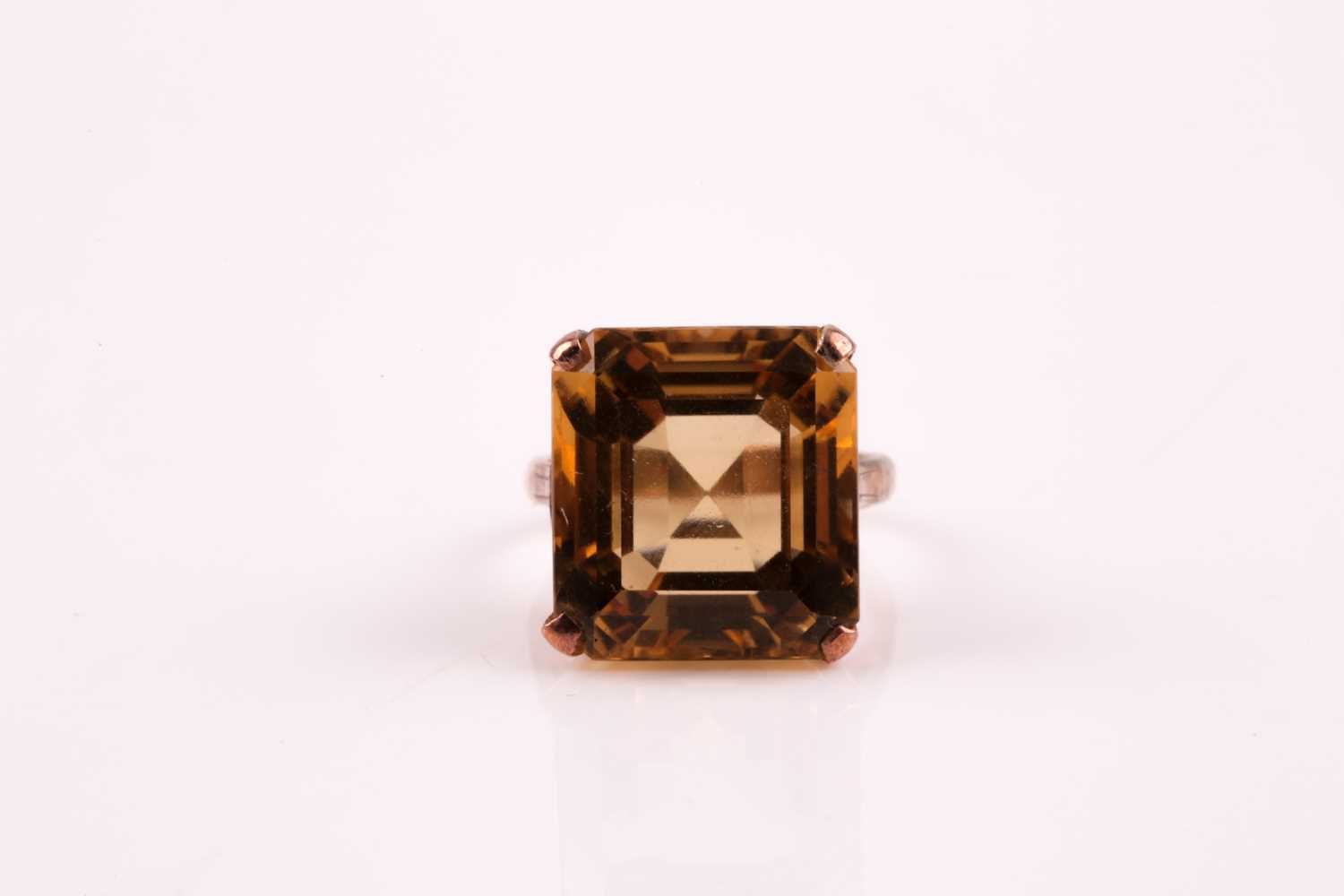 A single stone citrine ring, the square step-cut citrine, in four claw mount, foliate setting and