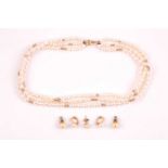 A 9ct yellow gold and pearl necklace, comprised of three strands of white cultured pearls, with