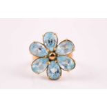A blue topaz cluster ring, the six claw mounted pear-shaped Swiss blue topaz in a flowerhead design,