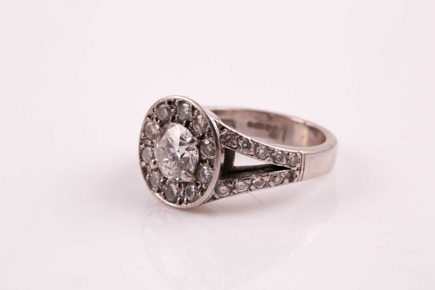 A diamond cluster ring, the central brilliant cut diamond in four claw mount above a channel set - Image 3 of 5