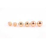 A pair of 18ct yellow gold ear studs, of textured rounded design, by Uno a Erre, together with two