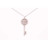 A Tiffany enchanted key pendant; the diamond set quatrefoil pendant of scrolling pierced design with