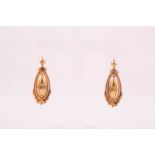 A pair of Victorian yellow metal drop earrings, of hollowed design, each with an elongated drop