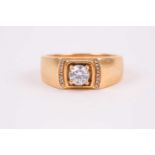 A yellow metal and diamond ring, set with a round-cut diamond of approximately 0.50 carats, with