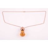 A 9ct rose gold mounted citrine Scottish thistle pendant, set with a faceted citrine, the rounded