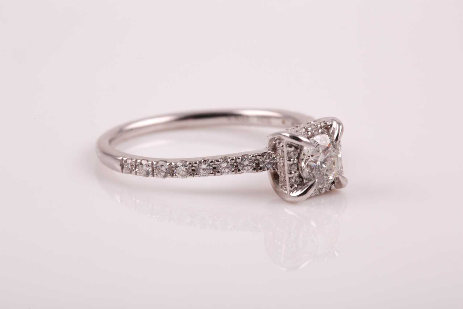 A 14ct white gold and diamond cluster ring, set with a round brilliant-cut diamond of - Image 2 of 7