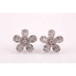 A pair of 18ct white gold and diamond floral cluster ear studs, the petals set with mixed baguette-