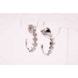 A pair of diamond cluster earrings, each curved mount set with seven floral clusters of diamonds,
